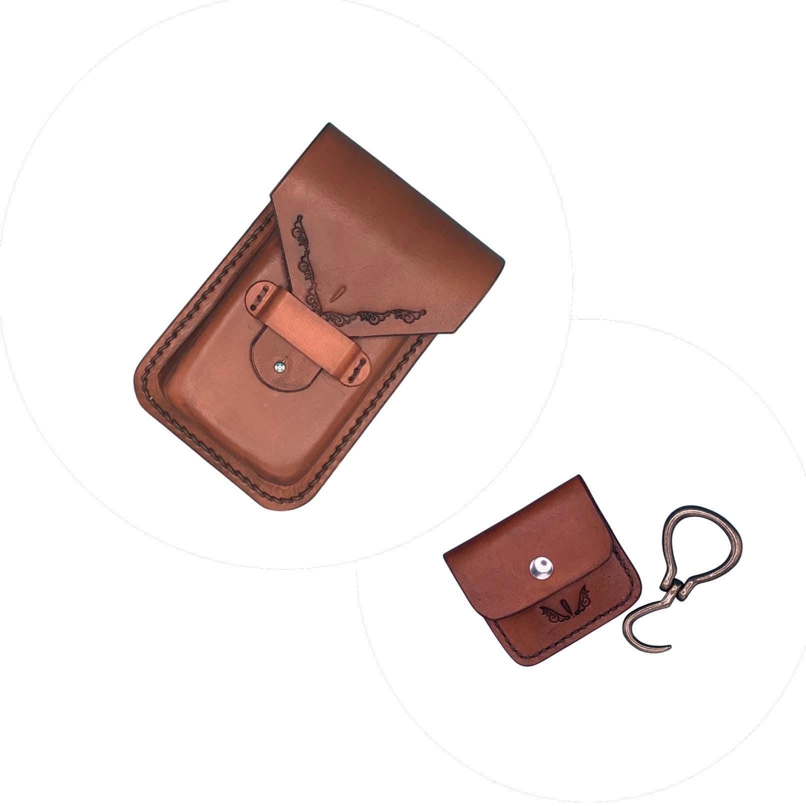 A light brown leather phone holder for saddle billet strap with a matching folding hoof pick holder.