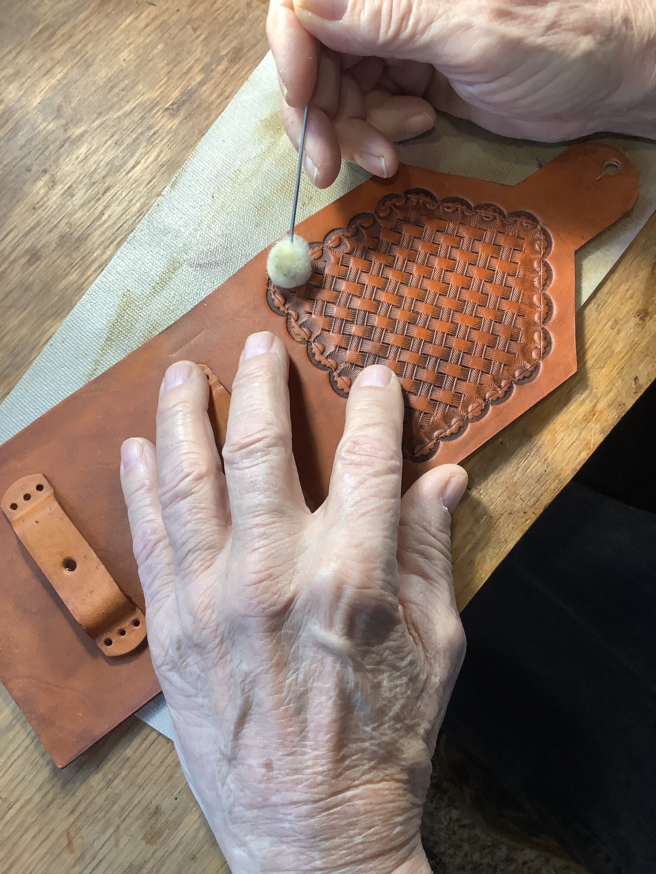Hank working on hand tooled leather.