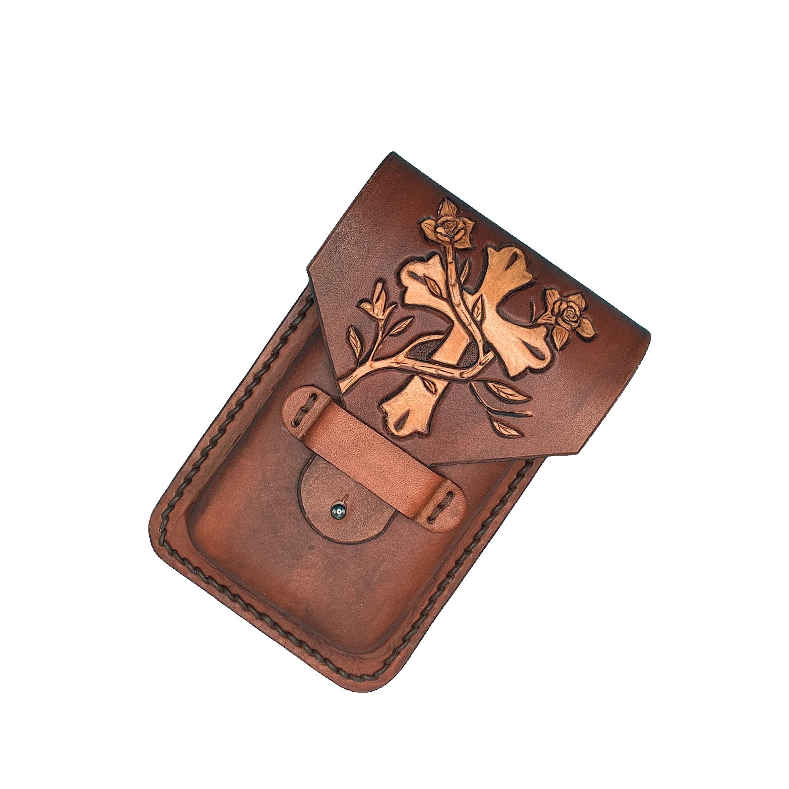 Hand tooled leather phone holder with cross and vine design.