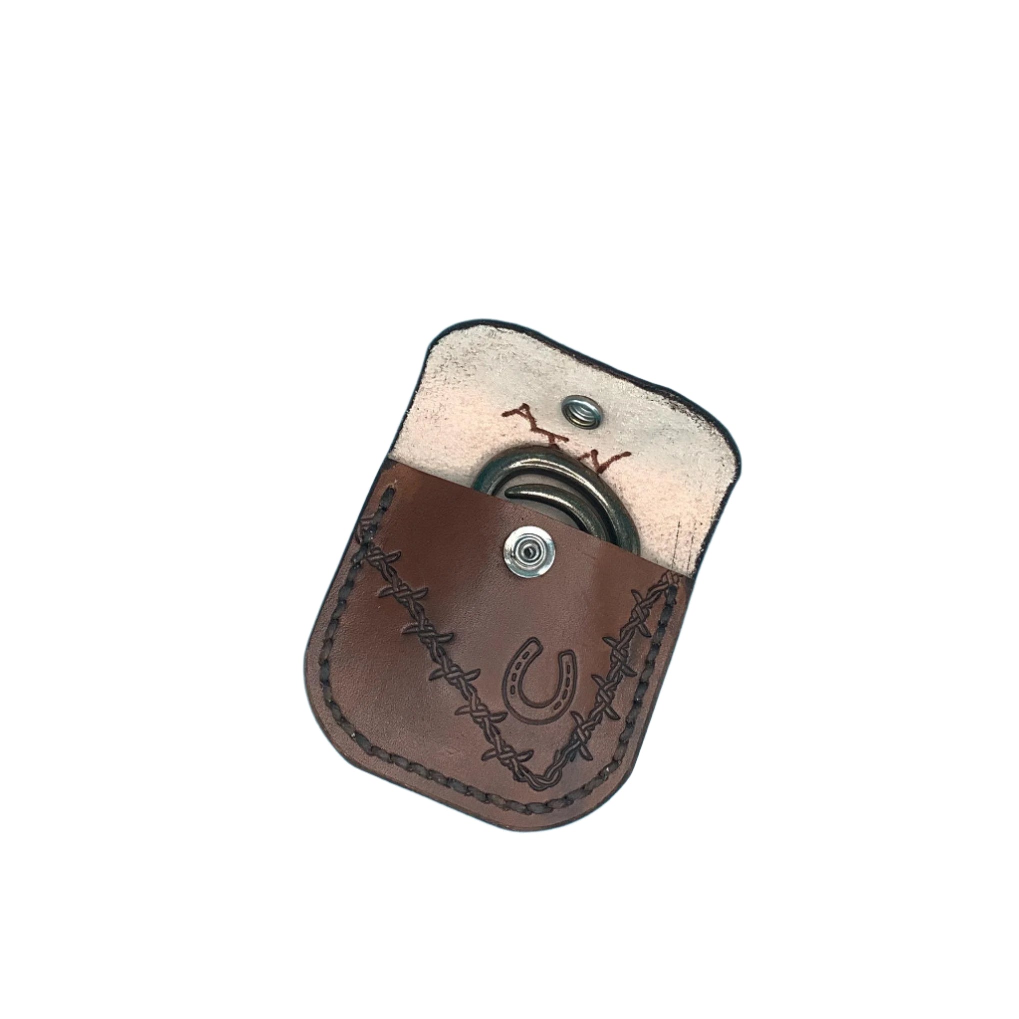 An open folding hoof pick holder for saddle billet with hand tooled horseshoe and barbed wire showing the hoof pick that comes with it.