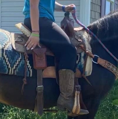A rider using a saddle phone holder.