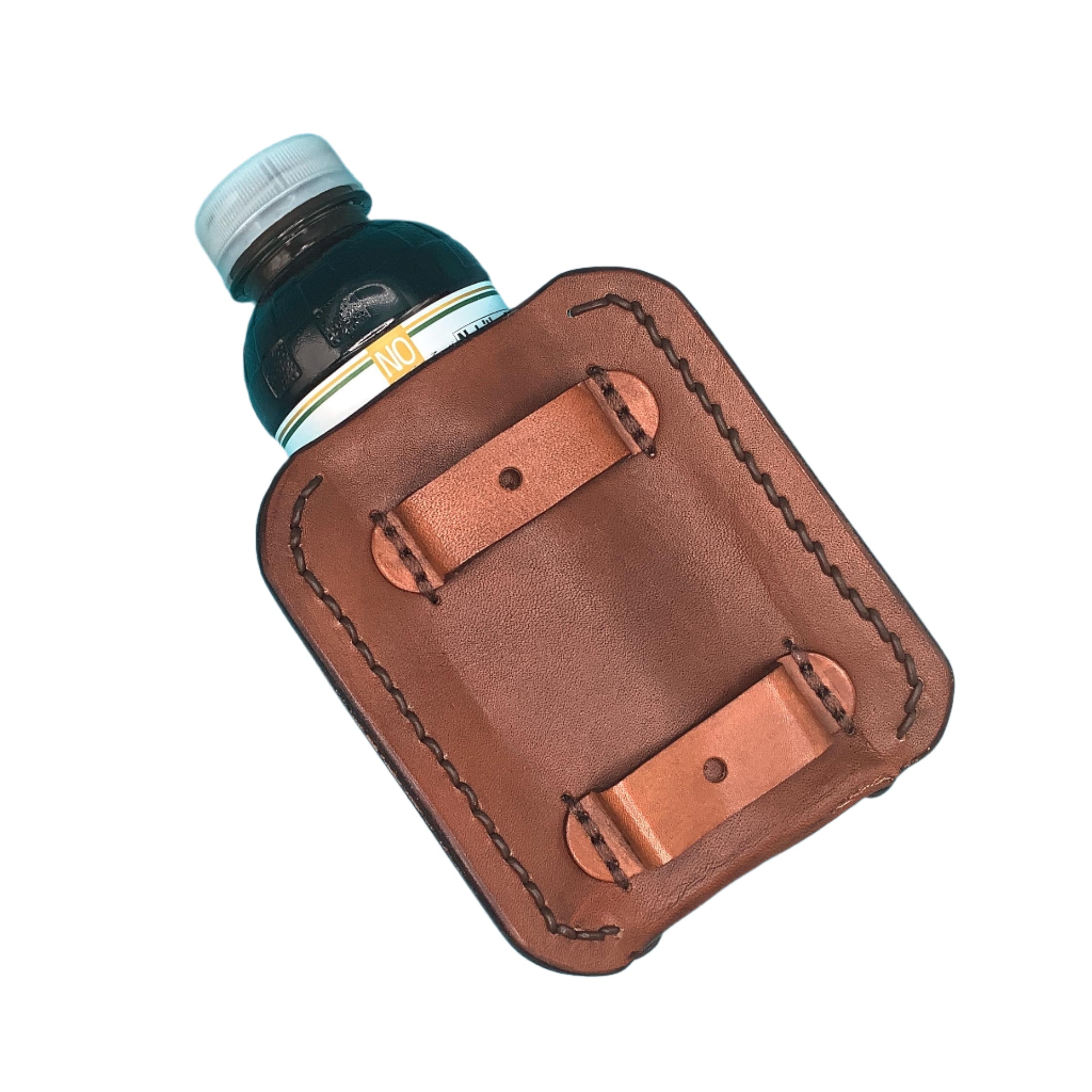 The back of a leather saddle bottle holder showing straps that attach it to the billet.