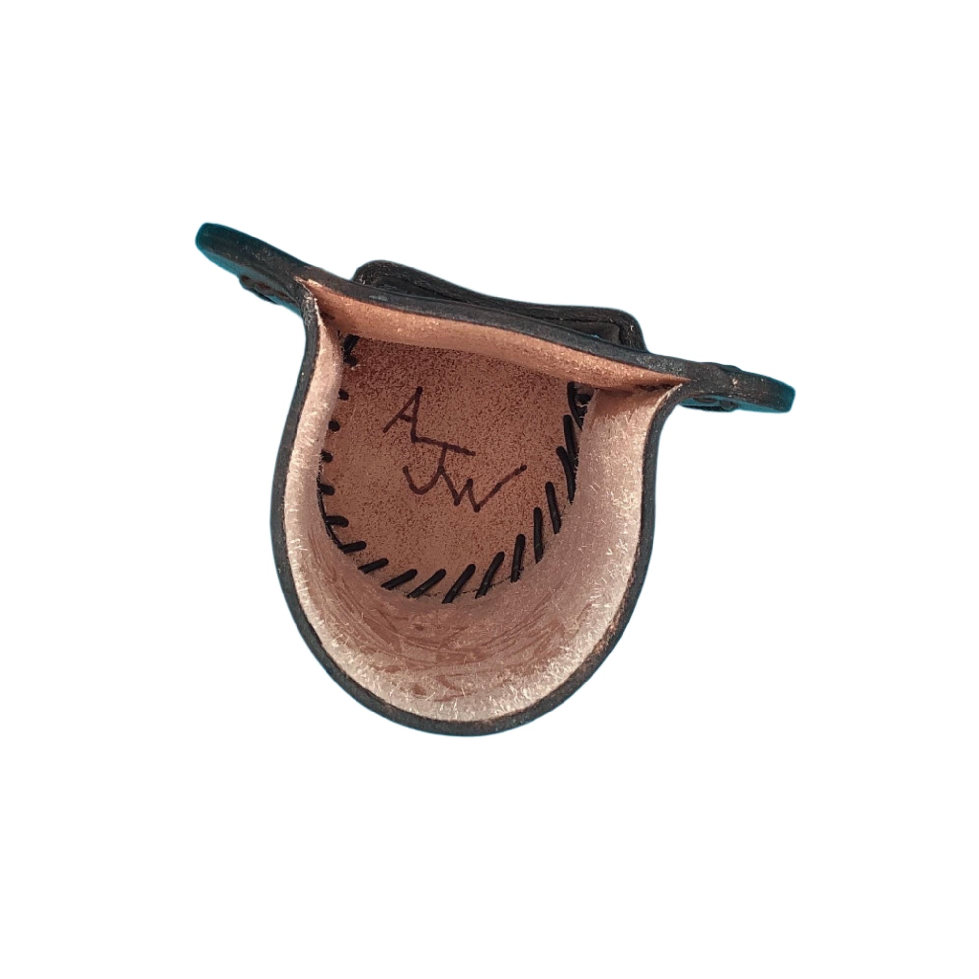 The inside of a medium brown leather bottle holder for a saddle billet with hand tooled cross and vine.