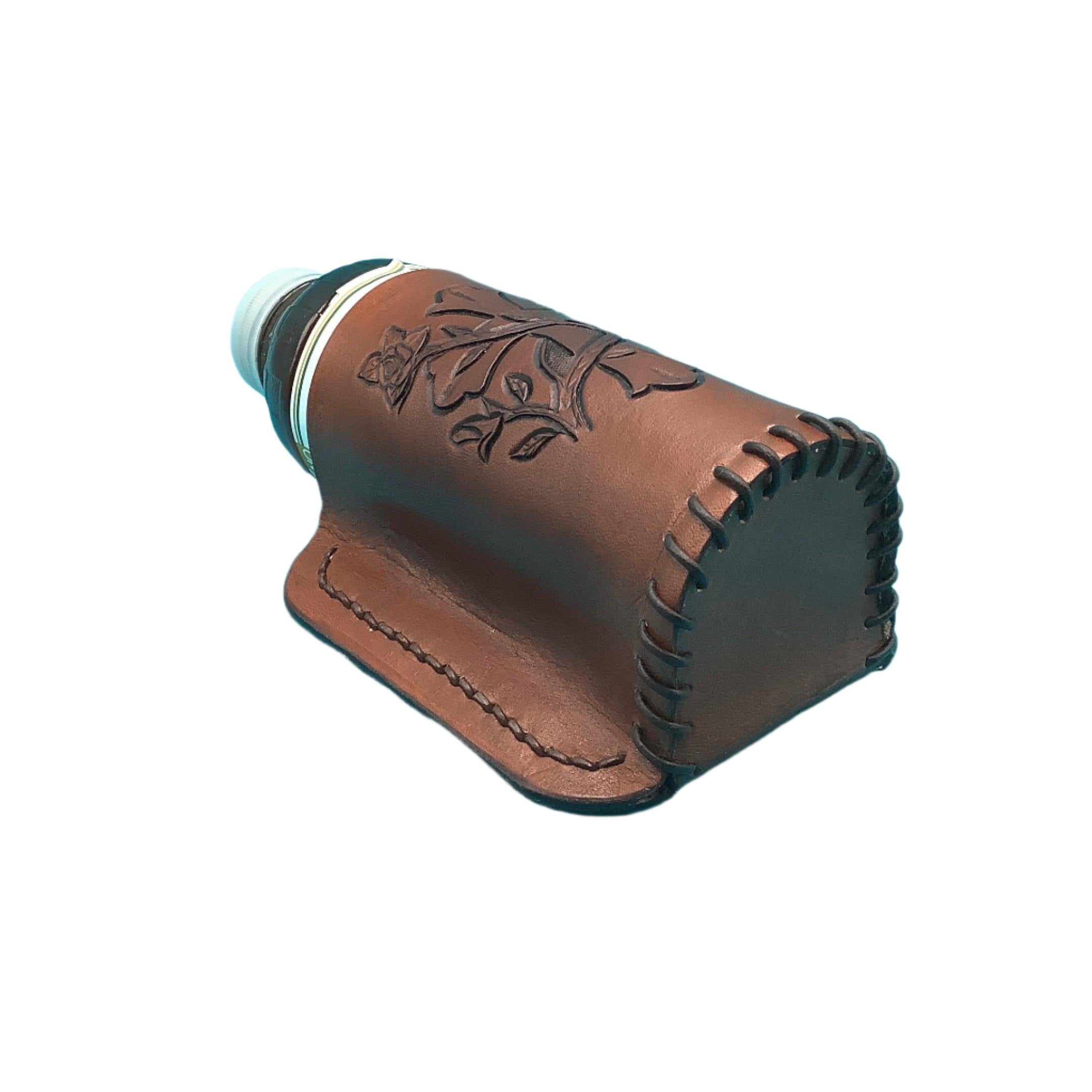 The bottom of a medium brown leather bottle holder for a saddle billet with hand tooled cross and vine.