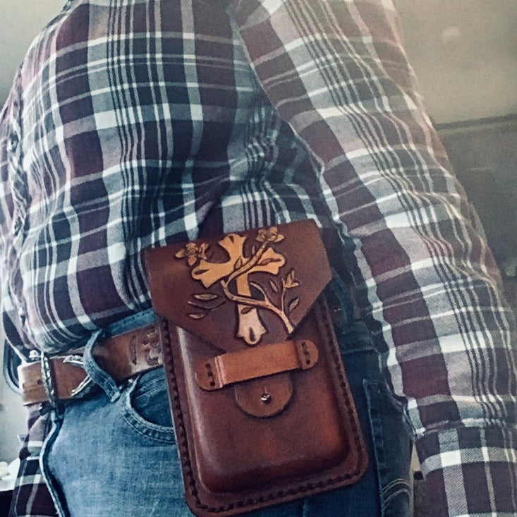 A hand tool leather phone holder shown on a belt.