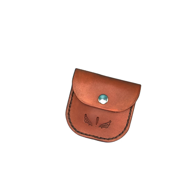 A close up of a saddle tan leather folding hoof pick  holder.