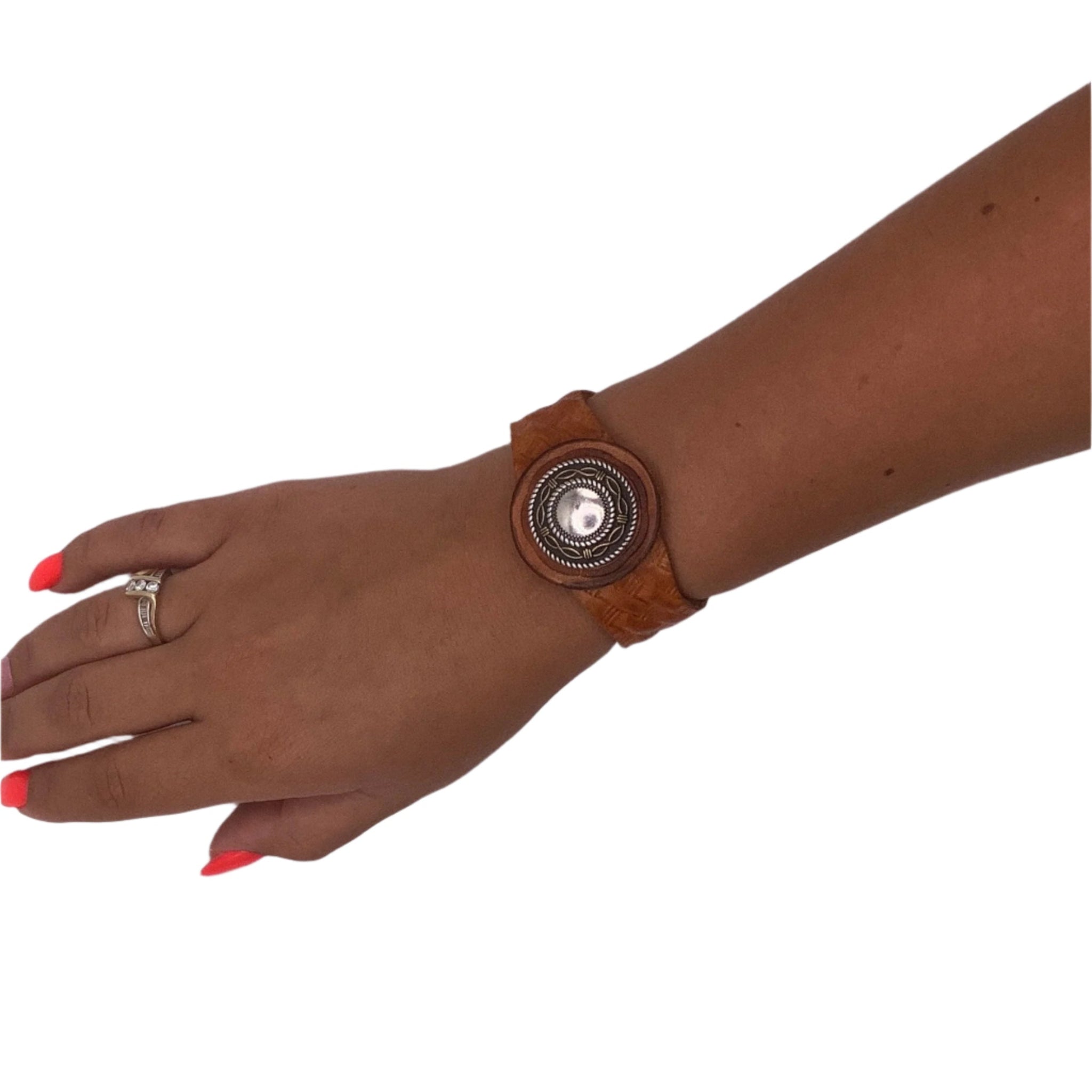 Leather basketweave bracelet with a decorative buttons and a stretch clasp. 