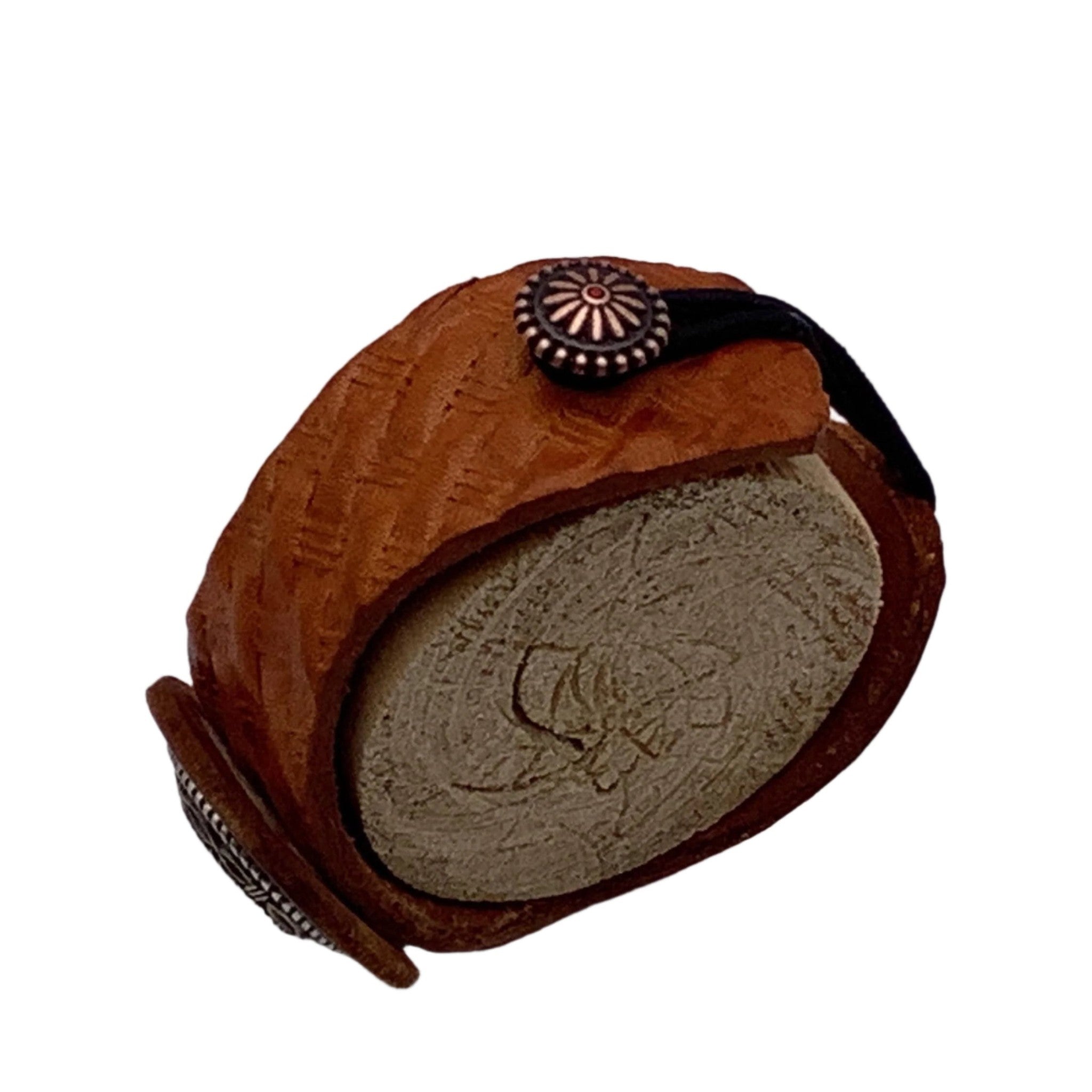 Close up of a leather basketweave bracelet with a decorative buttons and a stretch clasp. 