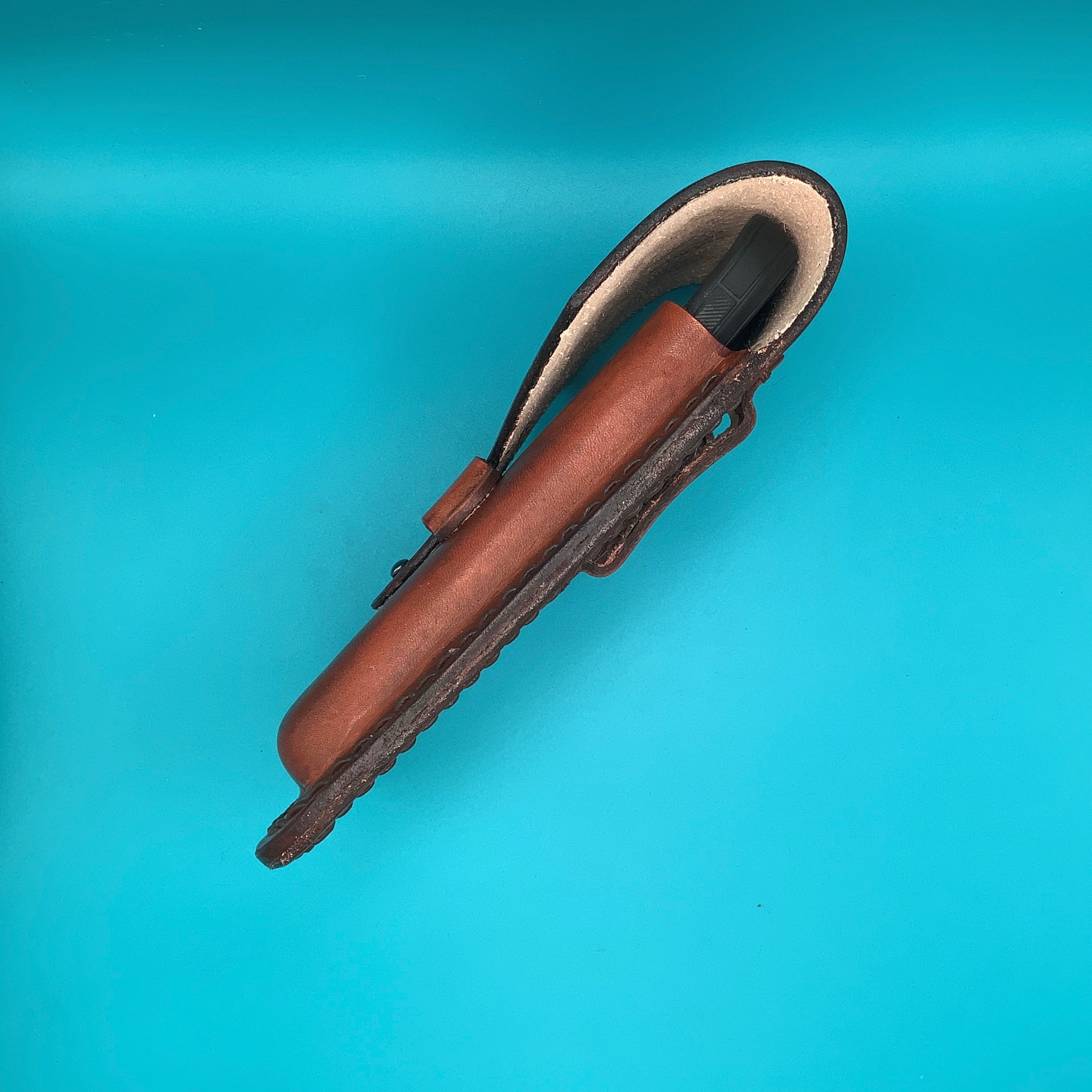 Side view of a leather phone holder.