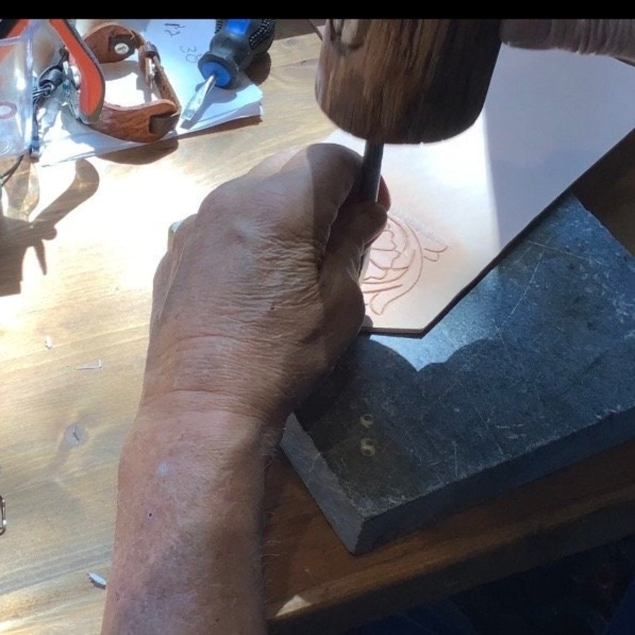 Hank working on hand tooled leather.