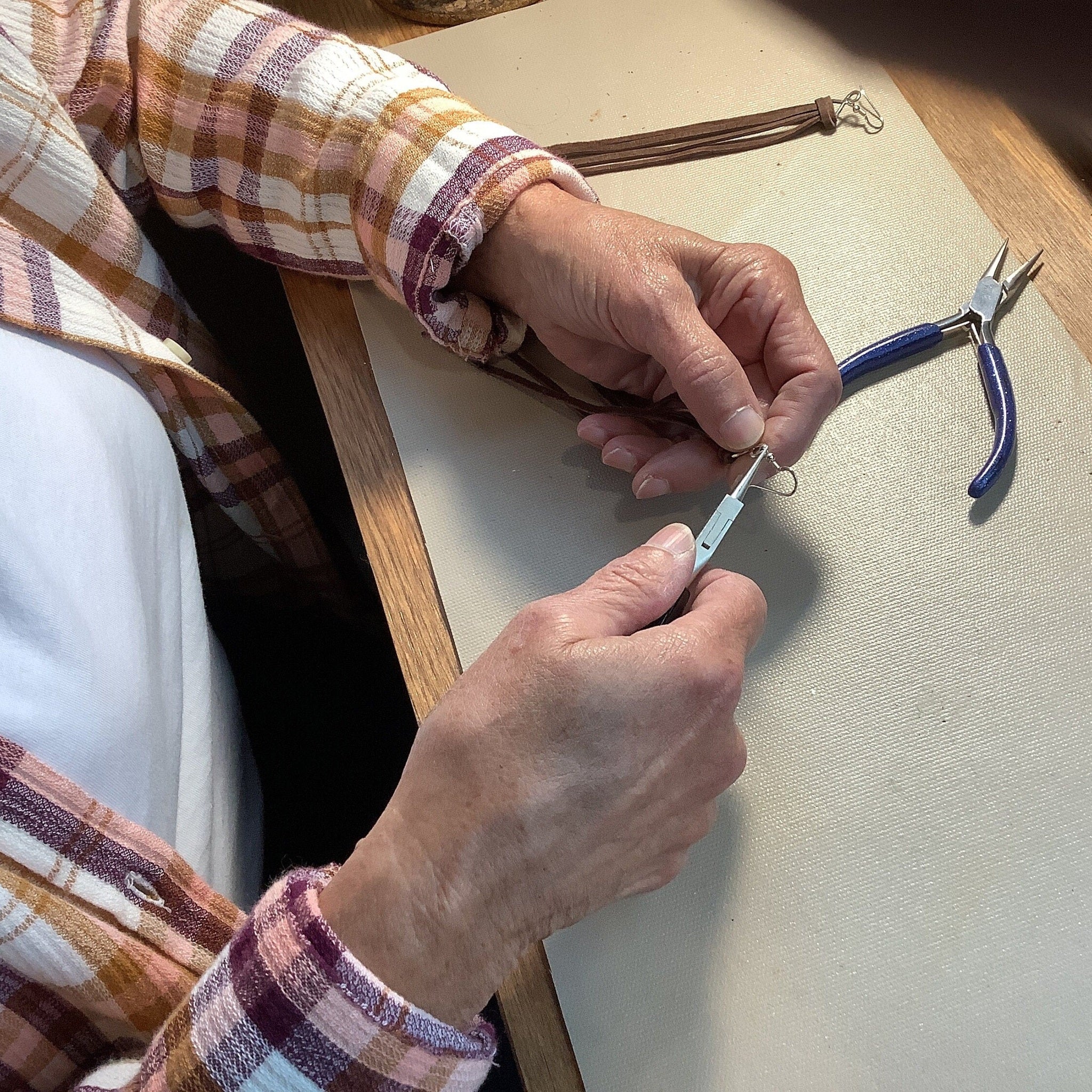 Rosa making handmade earrings. 
