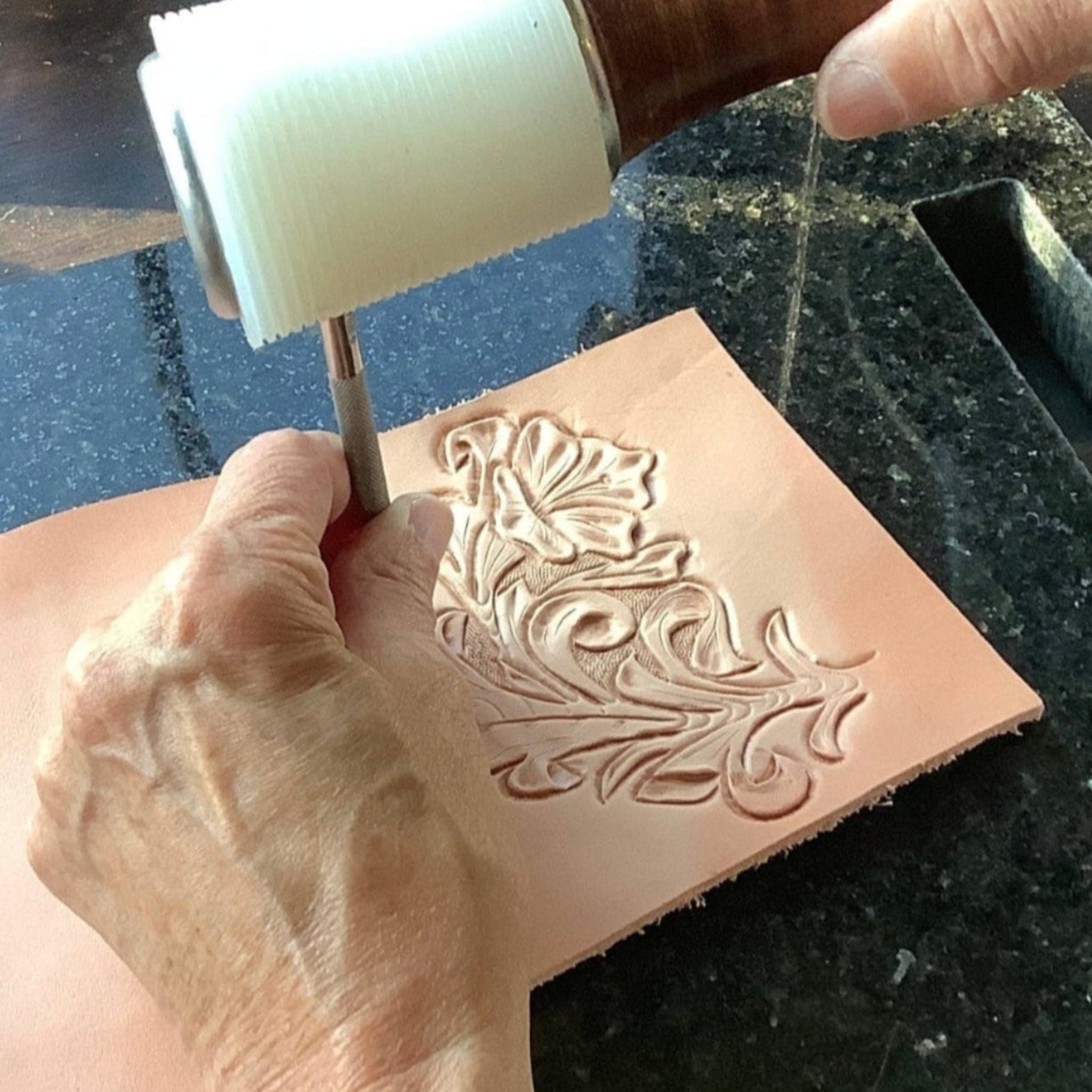 A person tooling leather.