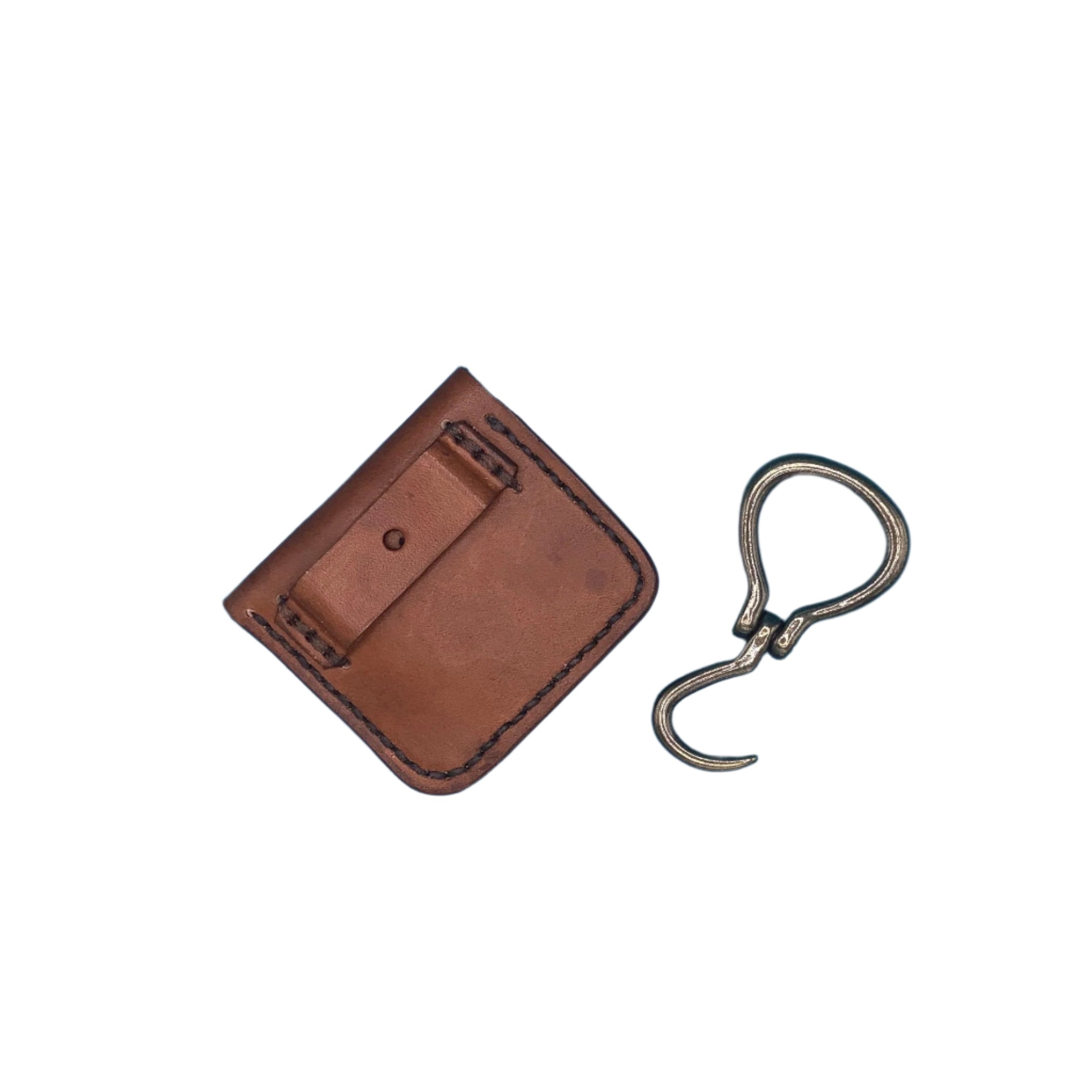 The back of a light browh folding hoof pick holder showing the strap that attaches it to the saddle.