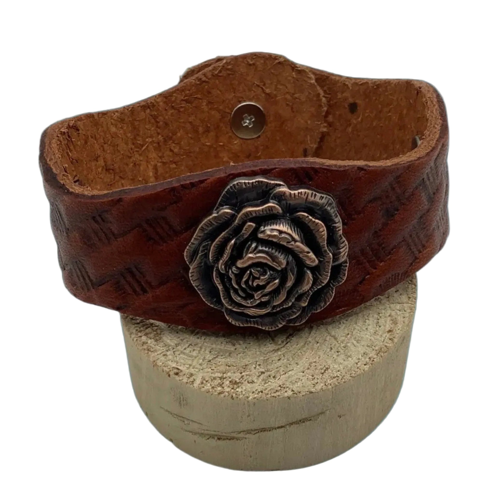  Close-up of basketweave leather bracelet with decorative copper concho.
