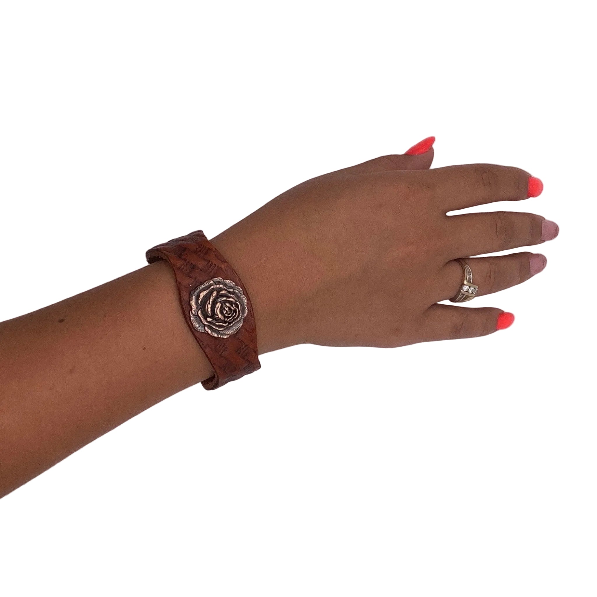 Western leather bracelet with basketweave tooling and decorative copper concho.
