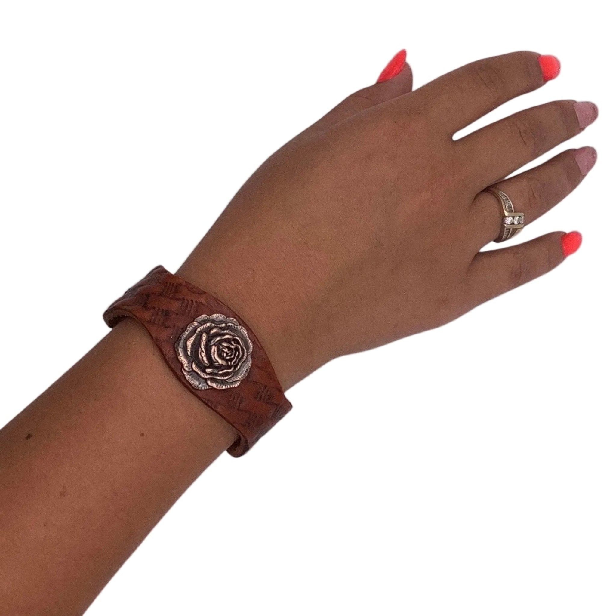 Leather cuff bracelet with basketweave tooling and copper rose concho.
