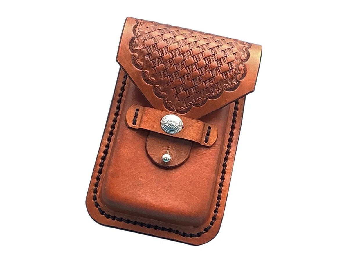 A saddle tan basketweave leather phone holder for saddle billet strap.