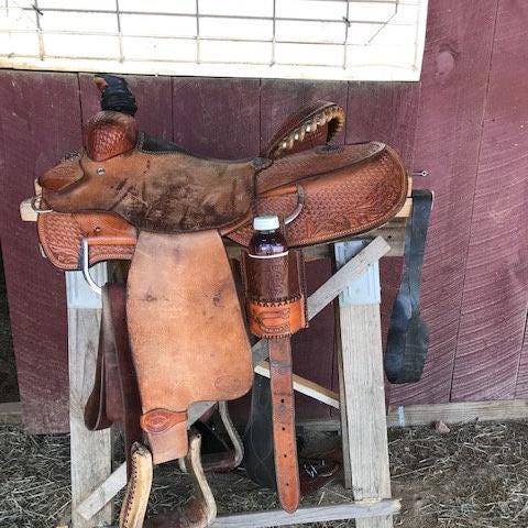 A rear cinch bottle holder shown on a saddle.