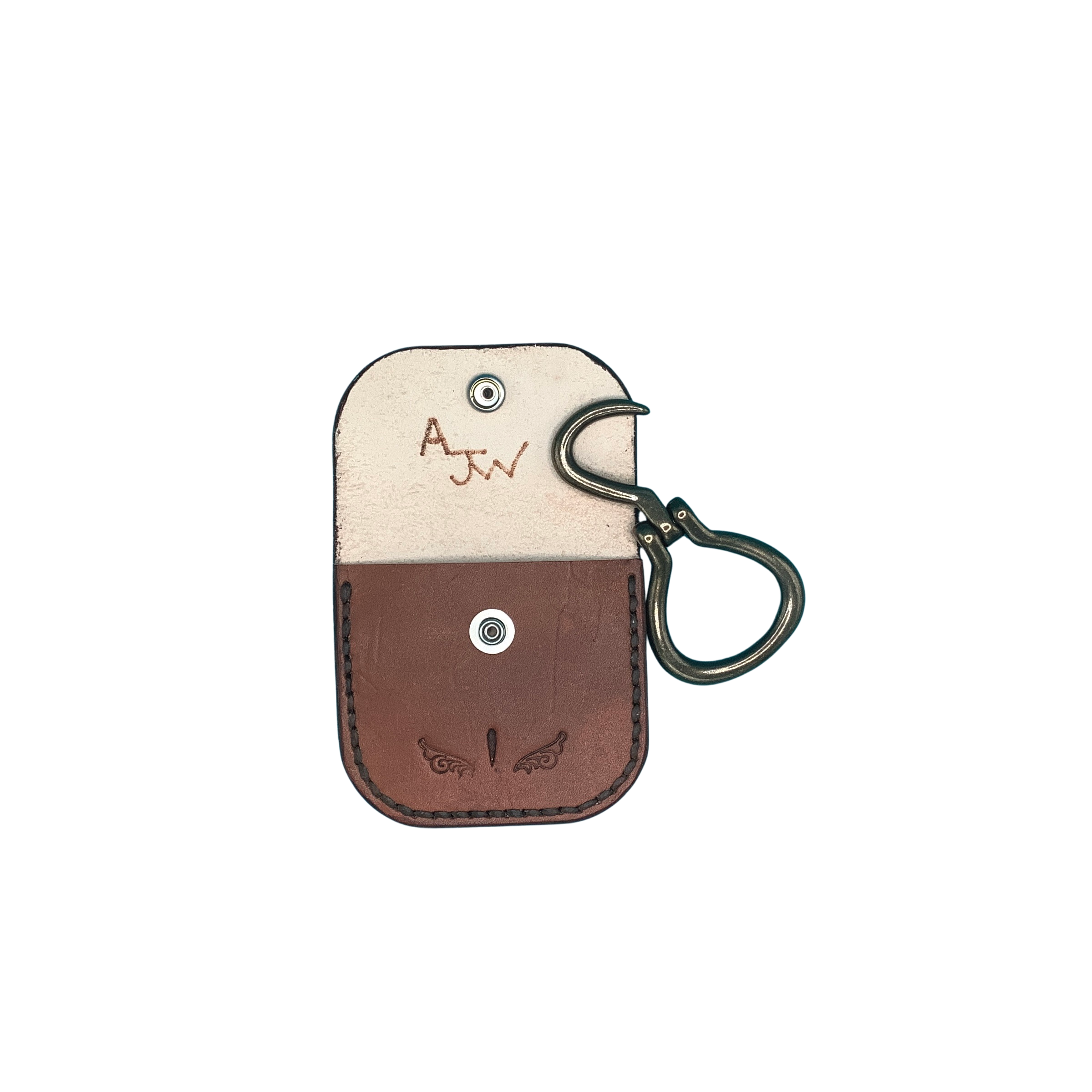 A hand tooled mahogany leather folding hoof pick holder with a brass folding hoof pick.