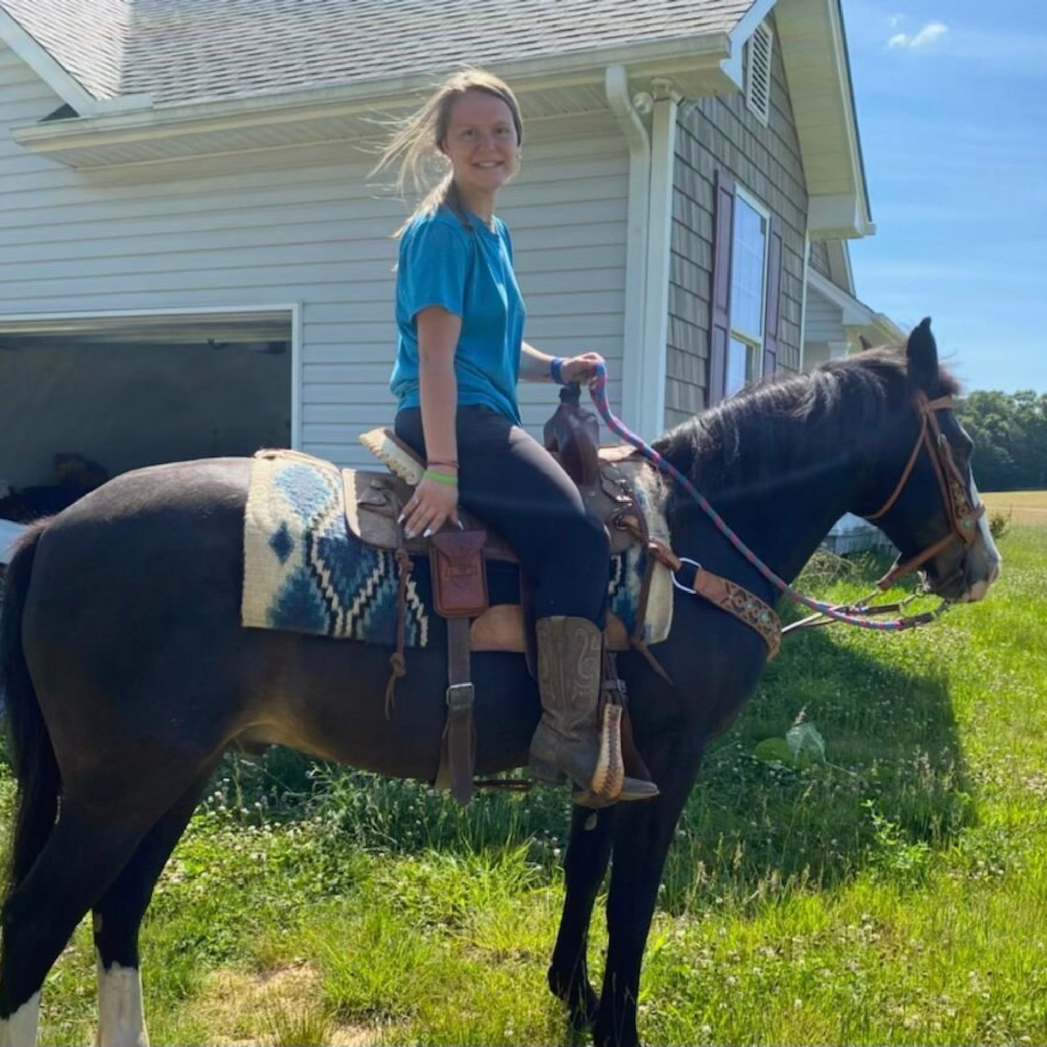 A horseback rider using a saddle phone holder.