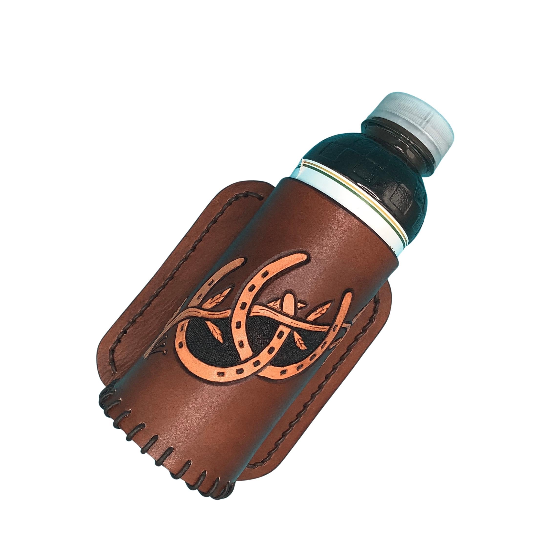 A medium brown leather saddle bottle holder with hand tooled horseshoes.