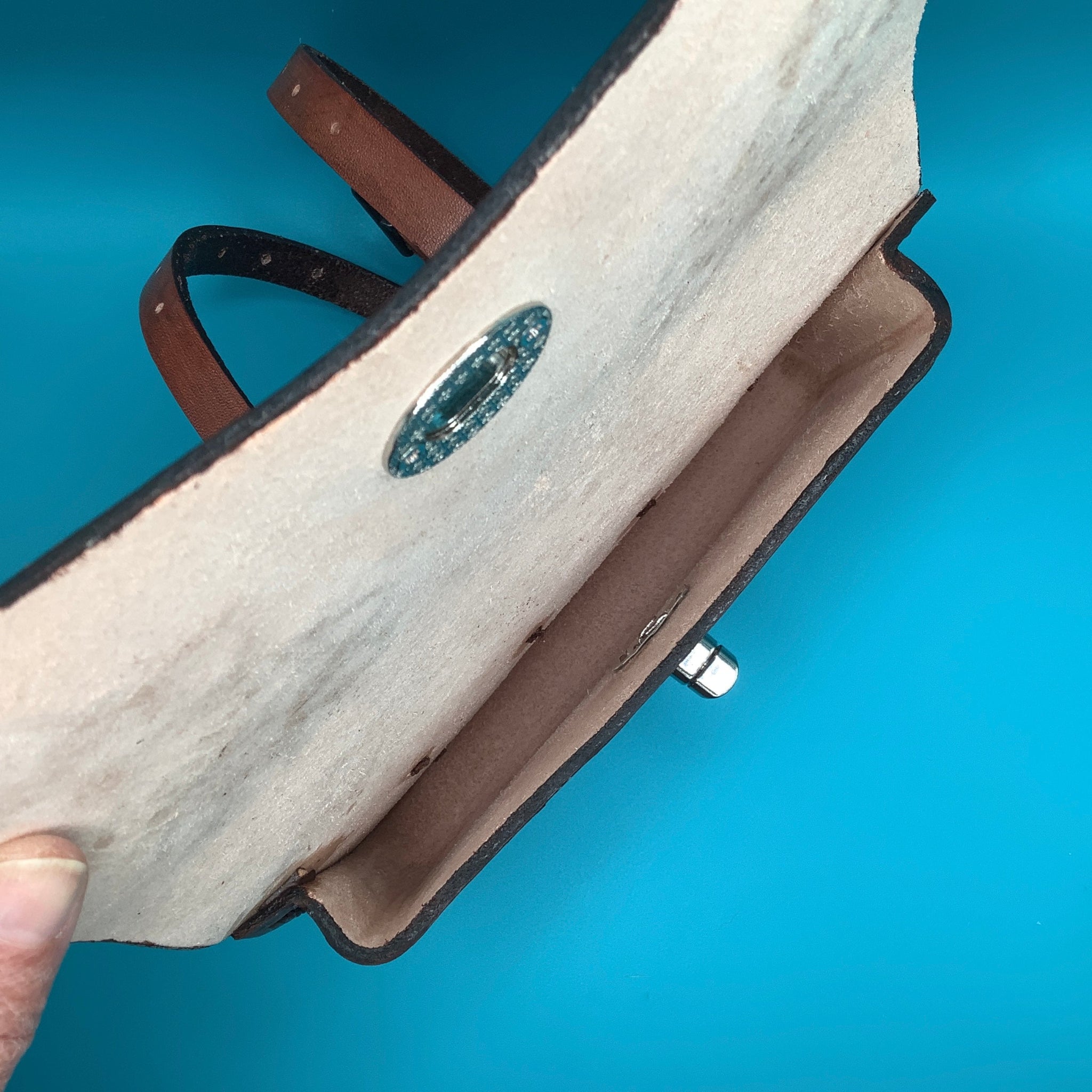 The inside of a leather pommel bag.