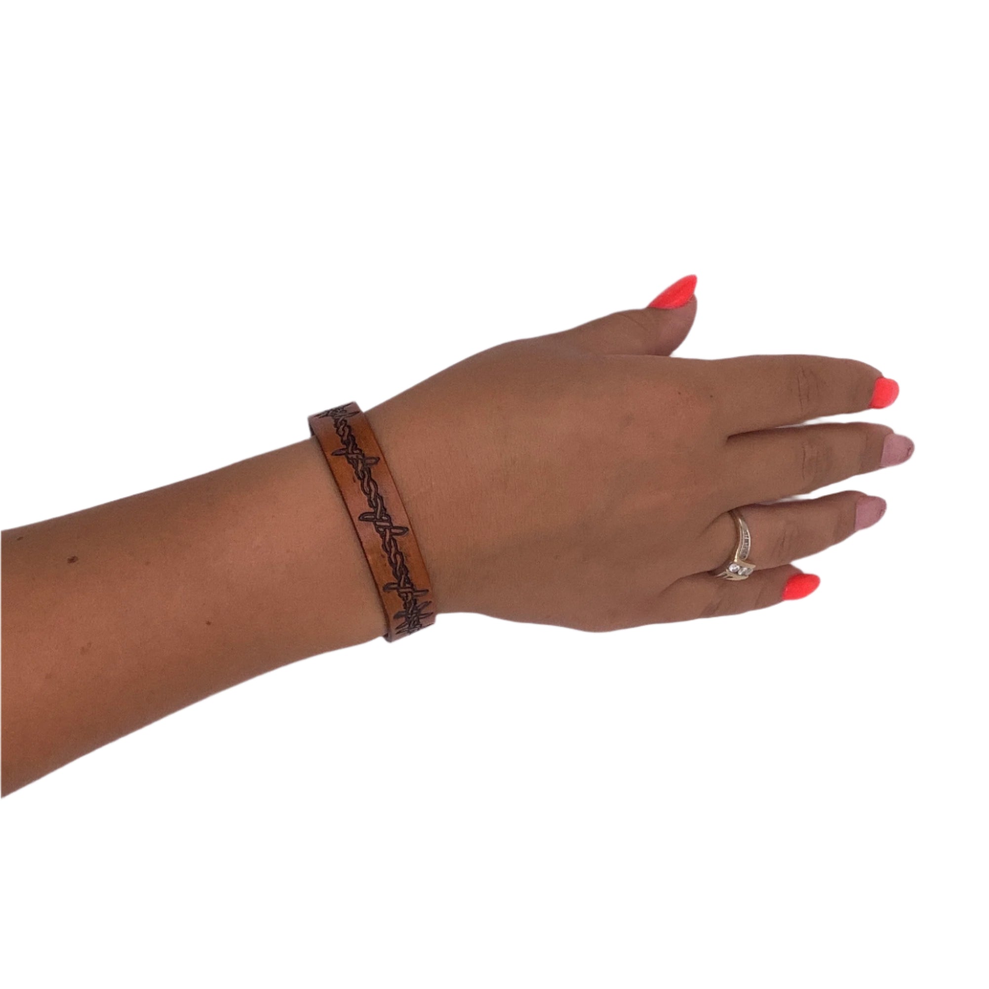 A model wearing a hand tooled leather bracelet.