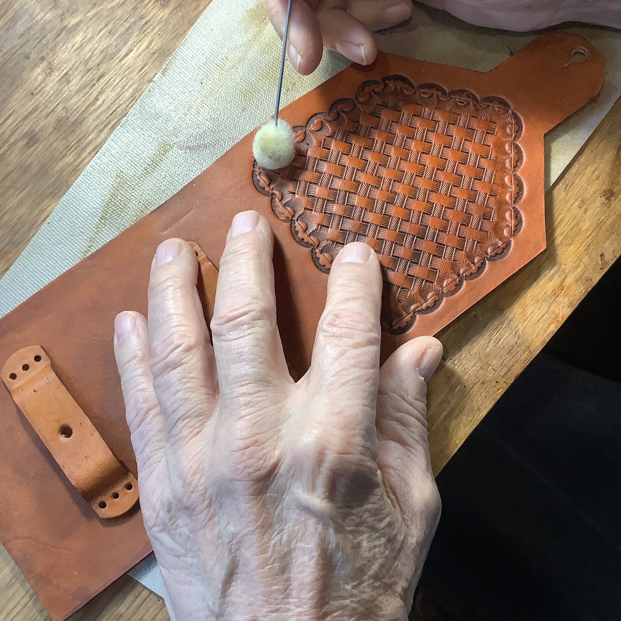 Hank working on hand tooled leather.