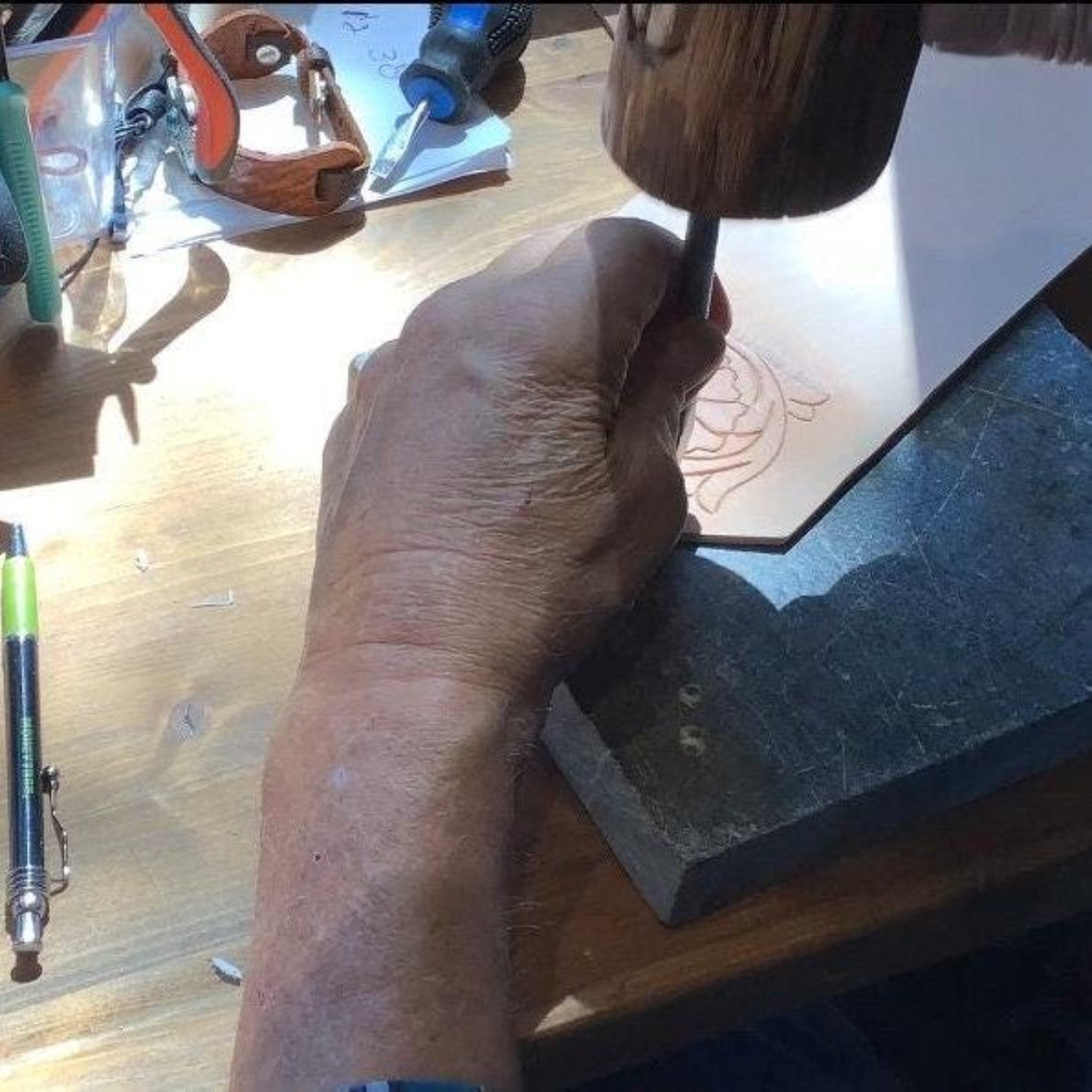 A leather worker tooling leather.