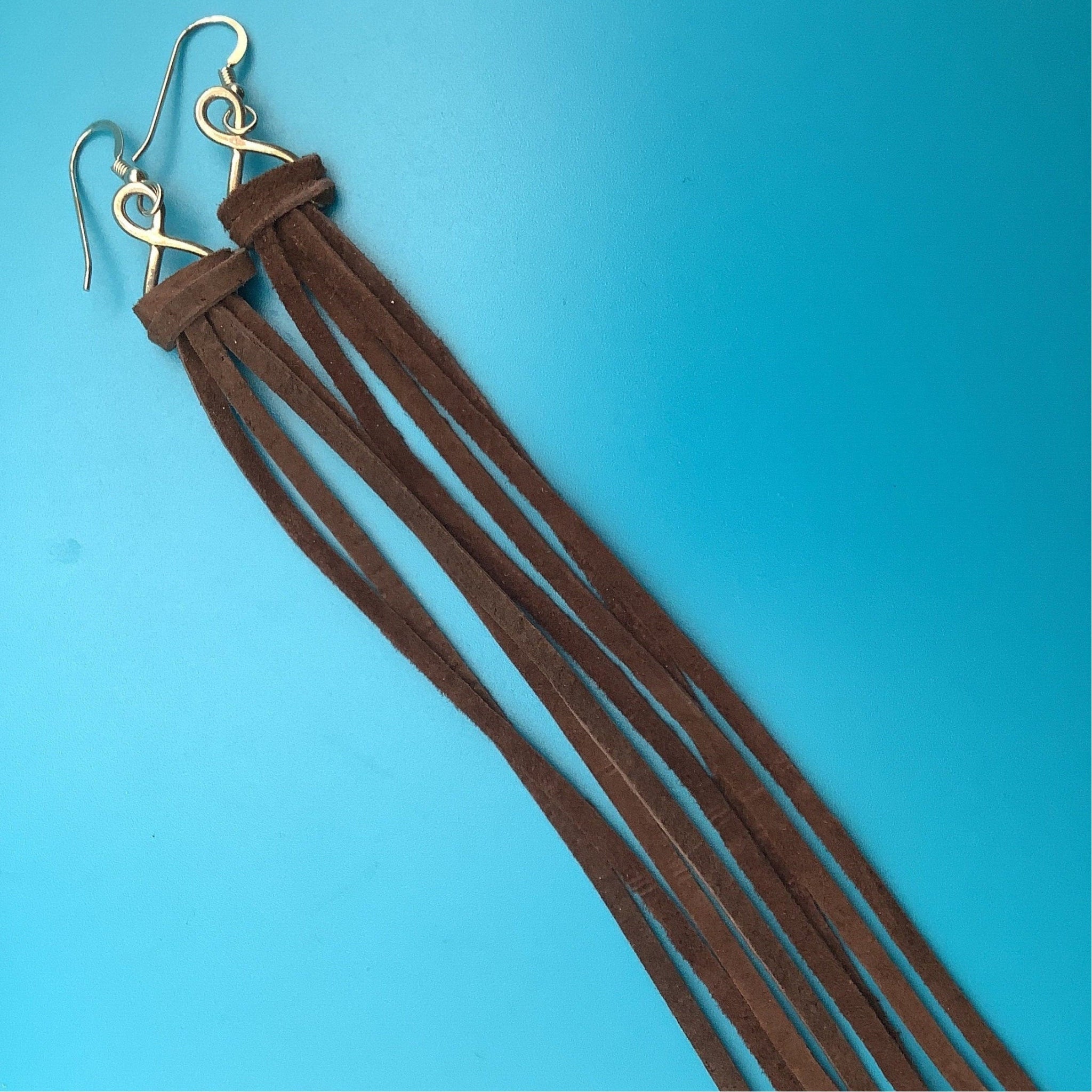 Western leather fringe earrings lightweight statement piece.
