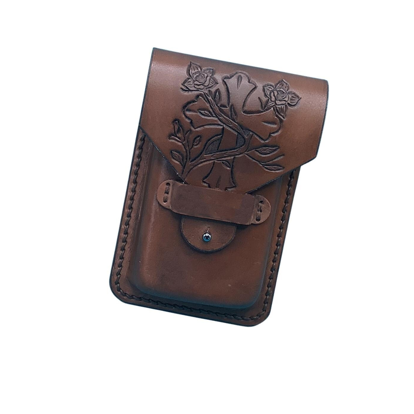 Medium brown leather phone holder for saddle billet with hand tooled cross and vine pattern.