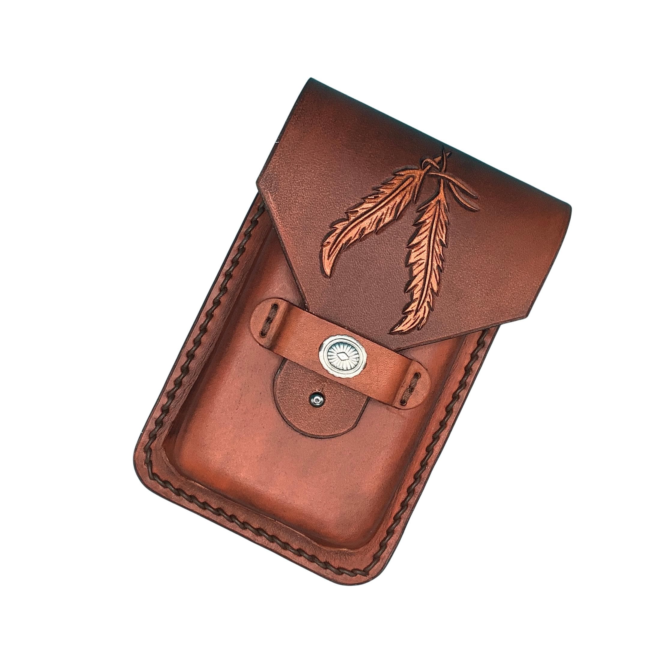 A mahogany brown leather phone holder for a saddle billet strap with hand tooled feathers.