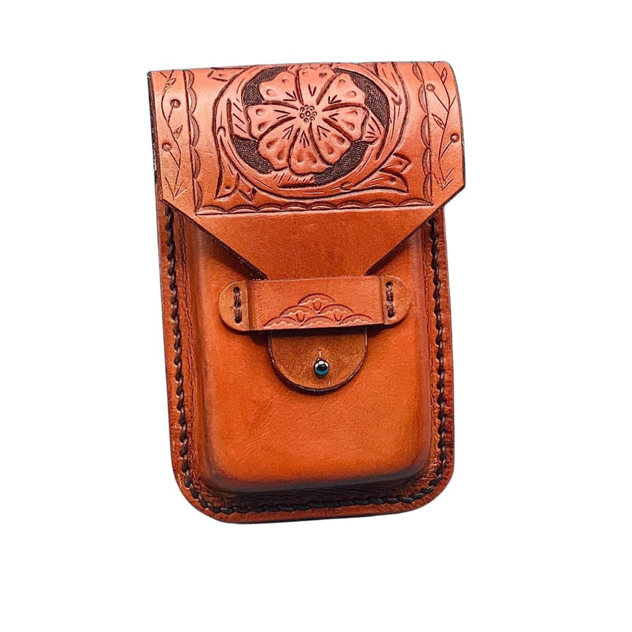 A saddle tan leather phone holder for saddle billet with a hand tooled saddle flower with border pattern.