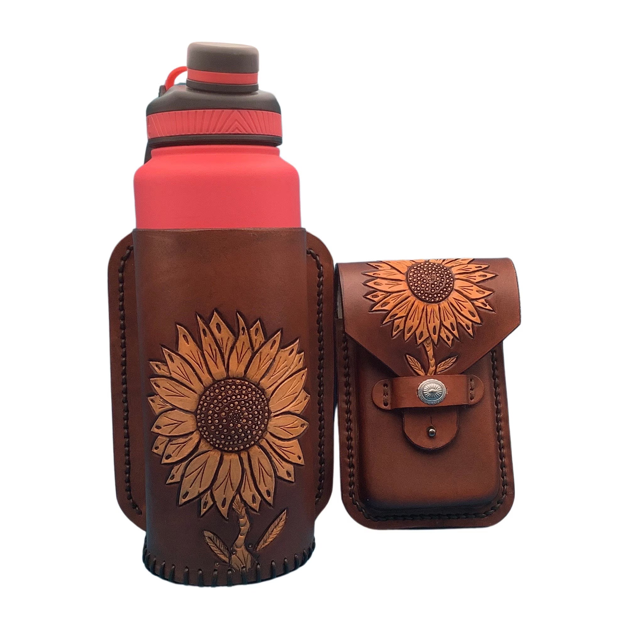 A leather phone and drink holder for saddle billet with hand tooled sunflower.