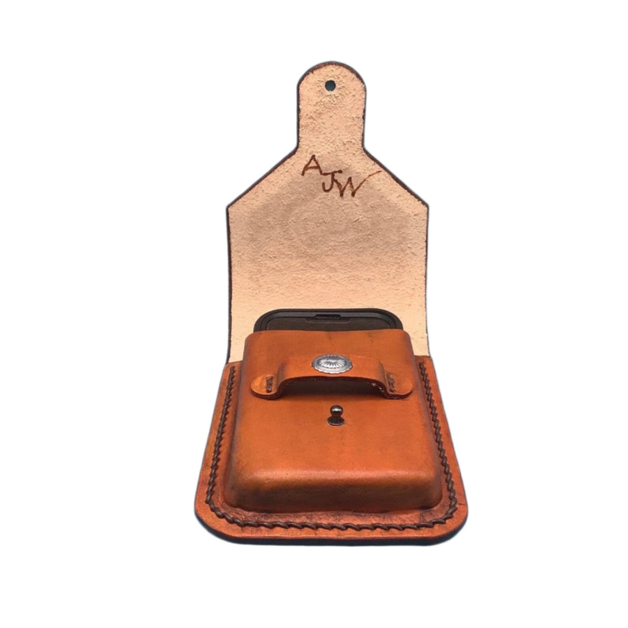 An open saddle tan leather phone holder for saddle billet strap.