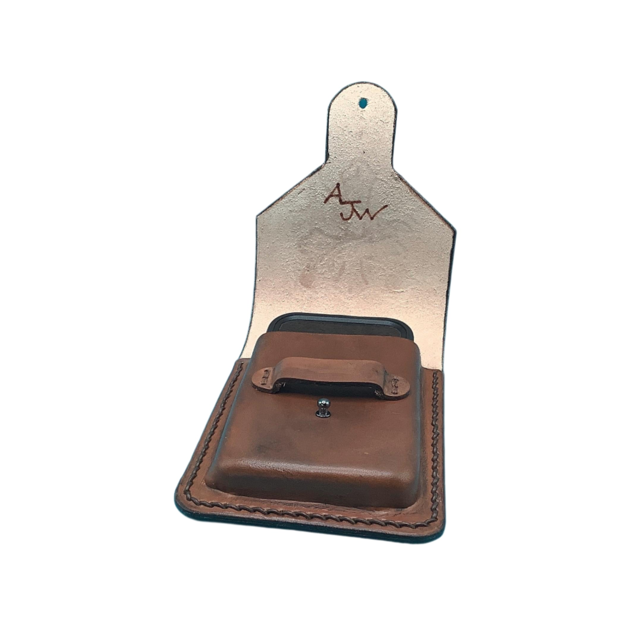 Hand-tooled cross and vine leather phone holder for saddle showing makers mark.