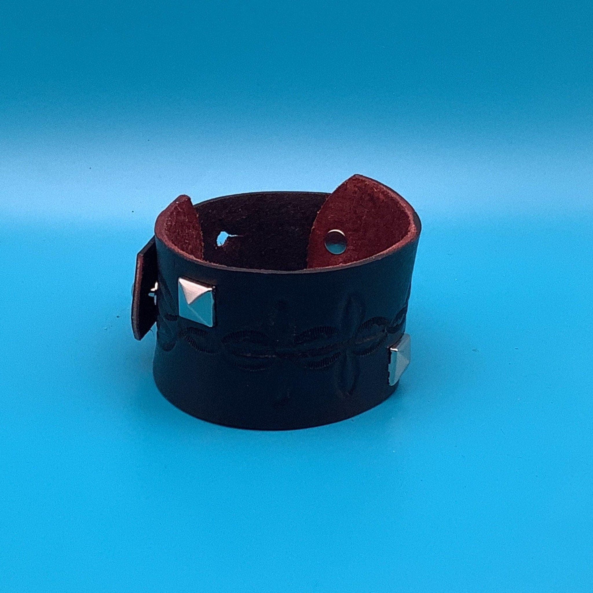 Hand-tooled wide leather bracelet with silver stud accents