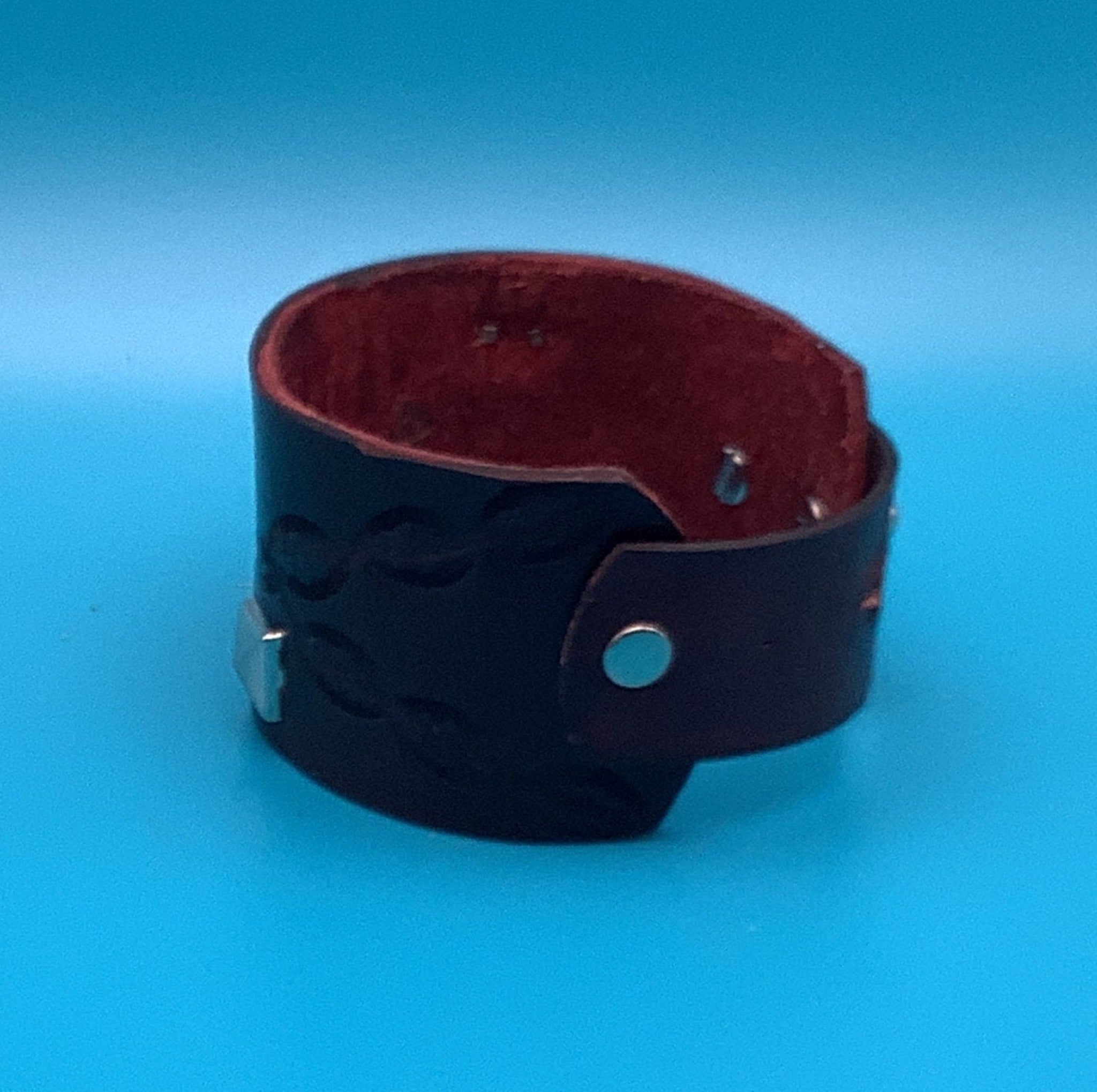 Wide western leather bracelet with silver studs and tooling