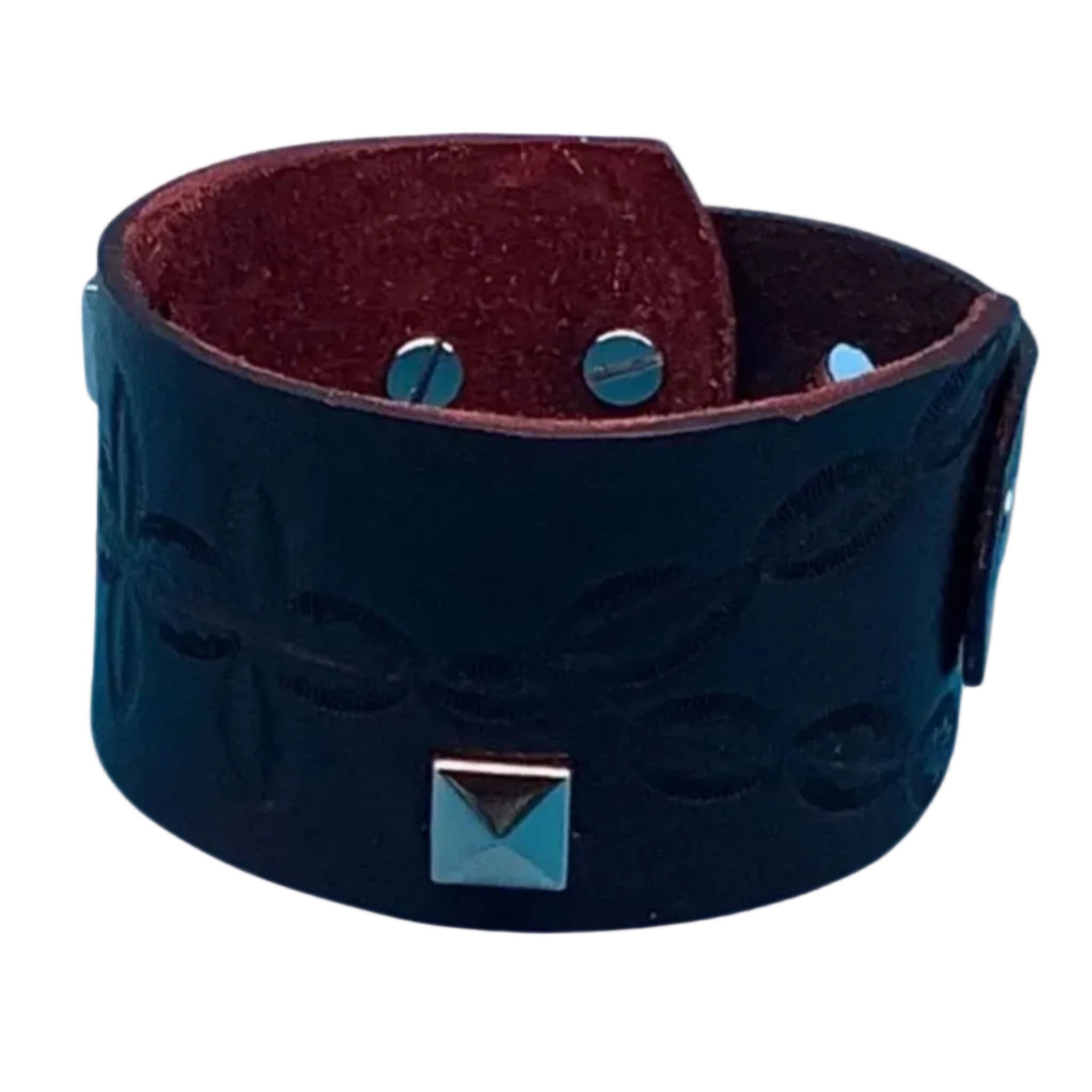 Wide leather bracelet with hand-tooled design and silver studs